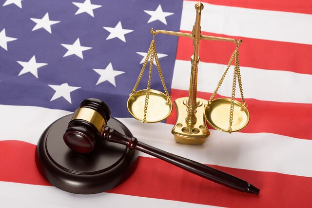 gavel and justice scale on a flag